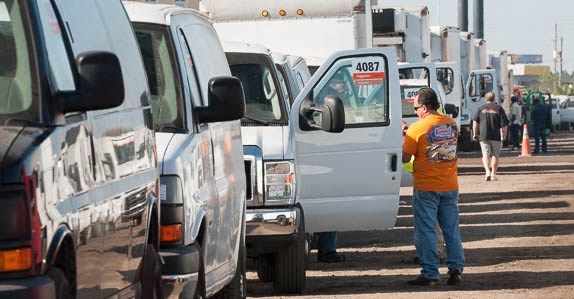A lineup of vans and van trucks waiting to be sold