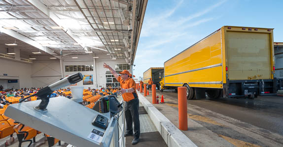 Fleet trucks make their way across the ramp as buyers place their bids