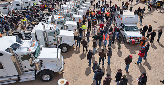 Bidders bidding on trucks at the Casper auction