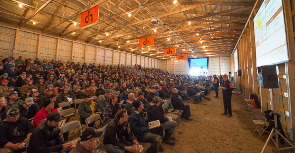 People bid on farm equipment and land at a Ritchie Bros. auction